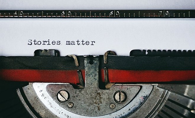 Typewriter typing out "stories matter"