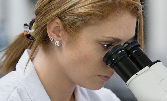 Student looking into microscope
