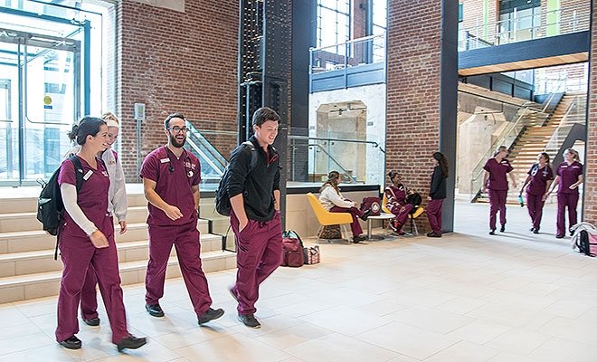 Nursing students walking into the RI Nursing Education Center
